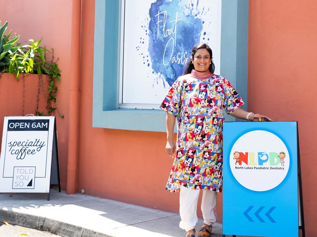 NLPD team member standing outside the clinic beside the practice signage