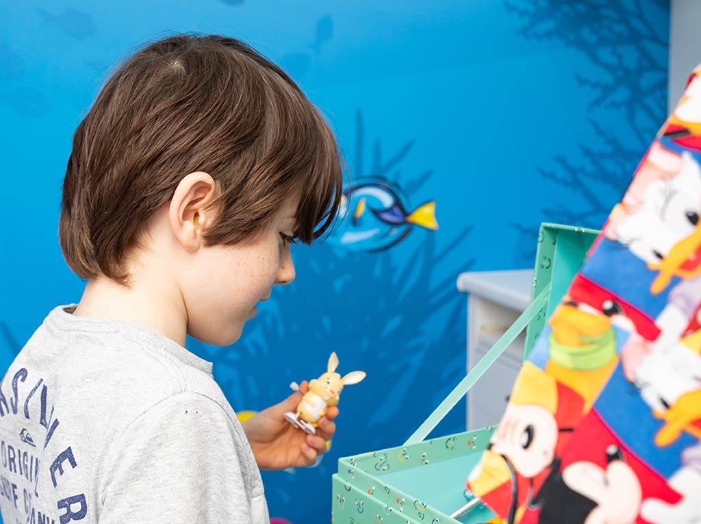 Young patient playing with a toy figure at North Lakes Paediatric Dentistry